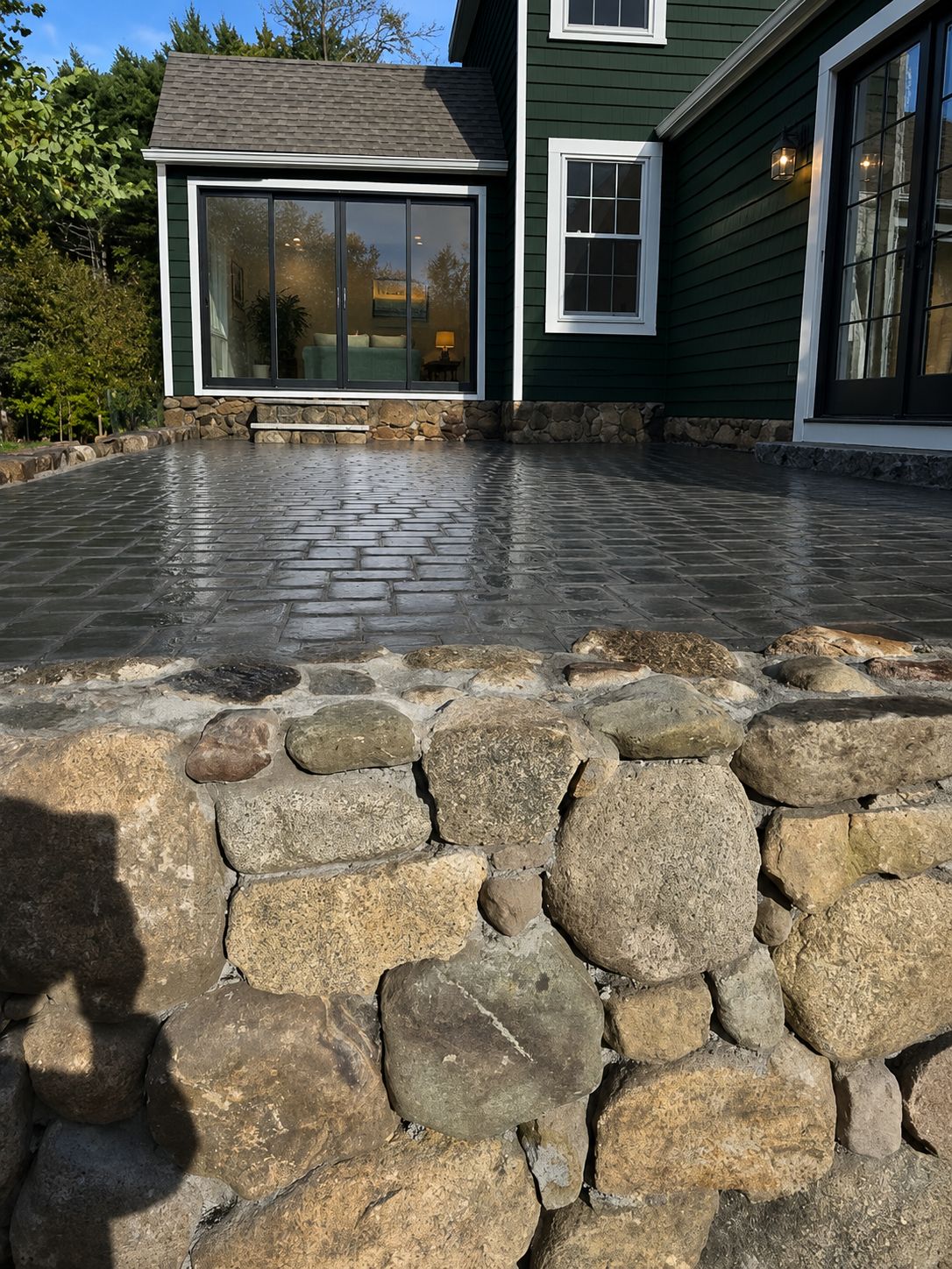 Paver patio with natural stone retaining wall